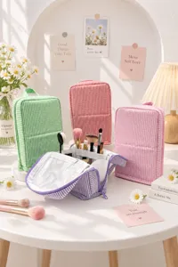Striped cosmetic bags in several colors, with the open purple pouch showing brush compartments