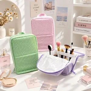 Vanity scene with striped pouches in three colors and an open organizer holding makeup brushes