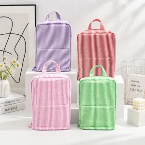 Four striped fabric organizers in purple, red, pink and green, with top handles and zip closures.