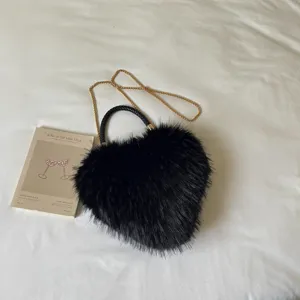 Black heart-shaped bag with shaggy faux-fur texture, woven handle and gold chain strap