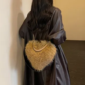 Rear view of a person carrying a brown heart-shaped faux-fur bag with braided handle and chain strap