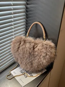 Heart-shaped taupe faux-fur handbag with braided handle and gold chain strap, shown upright