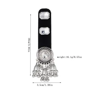 Silver-tone jeweled detail with dangling bell charms, shown on a black velvet display