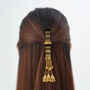 Rear view of a half-up hairstyle adorned with a gold hair ornament, chains and tiny bells
