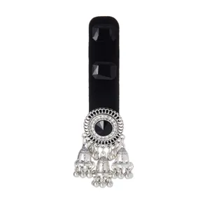 Antique silver-tone openwork centerpiece with a black stone and dangling bell charms