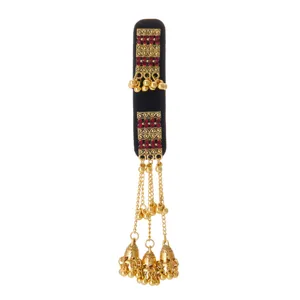 Gold filigree and red stones decorate a black velvet base with dangling bell chains and tassels