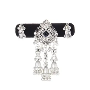 Silver-toned ornament with a black square stone, clear rhinestones, bells and dangling tassels