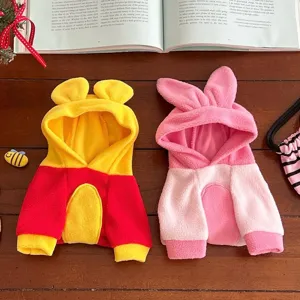 Two fleece hooded pet outfits laid flat, with ear-shaped hoods in yellow-red and pink colorways