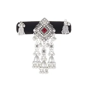 Silver-tone filigree pendant with red stone and dangling tassels and bells on a black velvet band