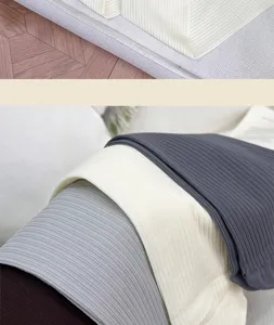 Close-up of vertical ribbing on stretch knit fabric in cream, white, gray and dark brown shades