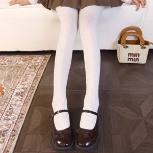 White ribbed stretch tights shown with a brown skirt and dark brown Mary Jane shoes
