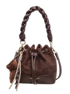Brown suede-look bucket handbag with diamond quilting, braided handle, drawstring and bear charm