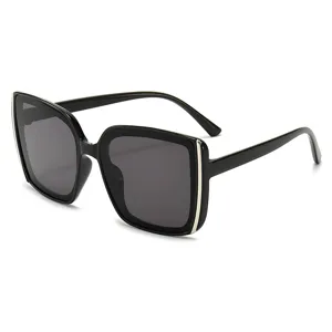 Oversized black square sunglasses with dark gray gradient lenses and silver accents