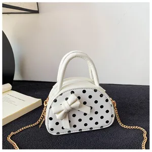 White domed mini bag with black polka dots, bow detail, twin handles and a gold-tone chain strap