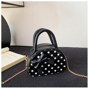 Black faux-leather with white polka dots, front bow, twin handles and gold-tone chain strap