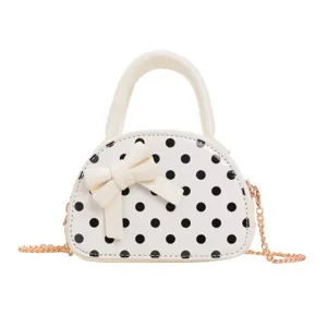 Front view of a white mini bag with black polka dots, bow detail and gold chain strap