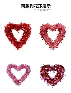 Four heart-shaped tinsel wreaths in red, pink and purple displayed in a two-by-two grid