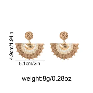 Pair of half-moon woven earrings with brown and ivory fibers, gold-tone accents and bead details