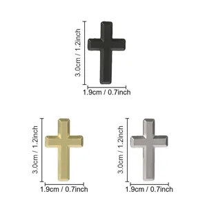 Three beveled metal cross ornaments in black, gold and silver, each measuring 3.0 cm by 1.9 cm