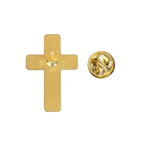 Close-up of the textured gold-tone cross pin back, with its metal post and butterfly clasp