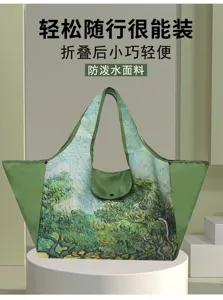 View of the painterly landscape print, green trim, and matching foldaway pouch on the tote