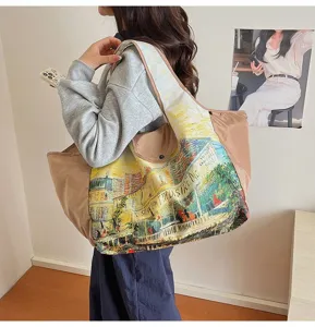 Lifestyle view of a woman carrying a beige tote with colorful oil-painting street print