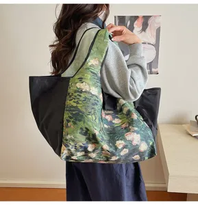 A woman carries a black bag with green oil-paint floral panels in a bright indoor setting
