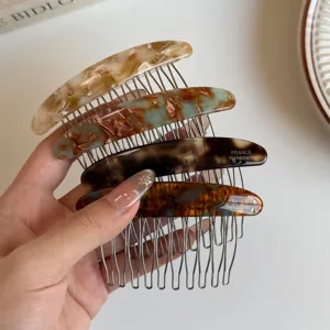 Hand-held set of four marbled resin hair combs with metal teeth in brown, teal and tortoiseshell