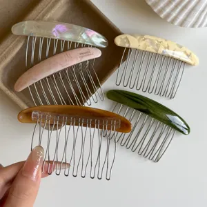 Five curved acetate hair comb clips in iridescent, pink, cream, amber, and dark green finishes