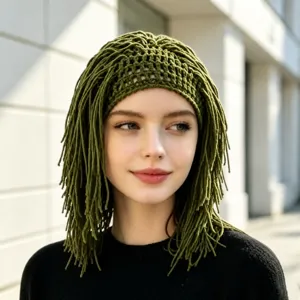 Outdoor portrait of a model wearing an olive green open-knit cap with long knitted fringe