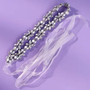Silver floral rhinestone bridal belt with double-row clusters and sheer white ribbon ties, laid flat