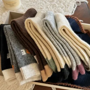 Women's thick Fair Isle knit wool-blend socks in assorted warm colors, neatly folded in a stack