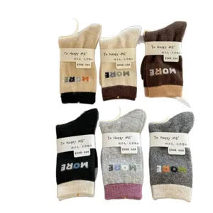 Six thick wool-blend crew socks in assorted colors, with contrast cuffs and letter motifs