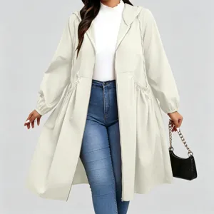 Full-length view of a model wearing a light cream hooded coat with a drawstring waist and flared hem