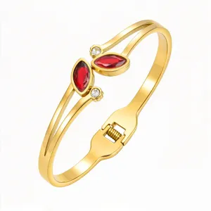 Gold-tone stainless steel cuff bracelet with twin curved bands, red marquise stones and clear accents
