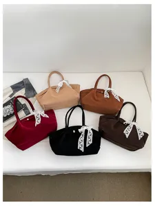 Five suede-textured bags in burgundy, camel, brown, black and dark coffee, with white lace bows