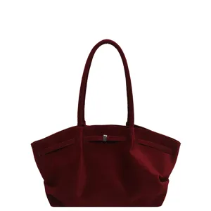 Burgundy suede-look tote bag with roomy curved body, double shoulder handles and front buckle detail
