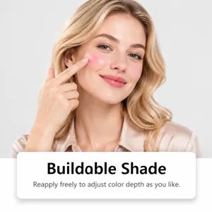 Model gently applies rosy blush to her cheek, showing a buildable color with a natural finish.