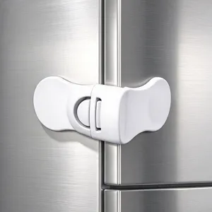 Close-up of a white plastic sliding latch fitted across the seam of a stainless steel fridge door