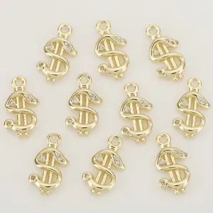 Close-up view of ten gold-tone dollar sign charms with clear stones and round hanging loops