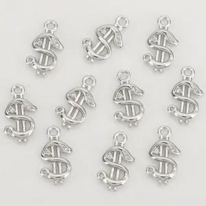 Ten silver-tone dollar sign charms with round loops, some set with clear stones, neatly arranged.