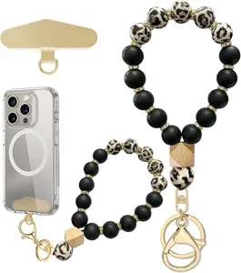 Close-up display of black and leopard-print beads, gold-tone spacers, clasp, key ring and phone tab