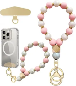 Flat lay of pink and white pearl-look beads with gold spacers, wooden accents and phone fittings