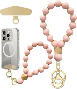 Pink beaded wrist straps with gold-tone spacers, wooden beads, clips, phone tether patch, and clear case