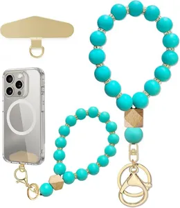 Flat lay of teal silicone bead wrist straps, wooden accents, gold-tone clips and phone tether tabs