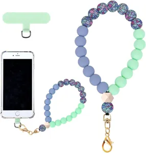 Detail view of blue-violet and mint beads with patterned accents, gold clasp and phone connector