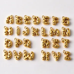 Gold balloon-style A–Z letter charms with round cutouts and top loops on a white background