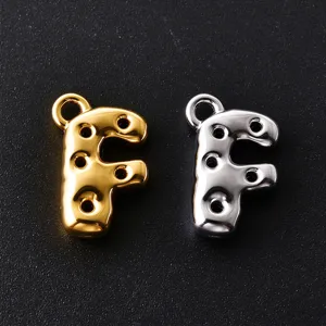 Close-up of gold and silver bubble-style F charms with circular holes and top hanging loops