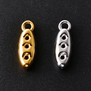 Close-up of polished oval metal charms with three round holes, shown in gold and silver finishes
