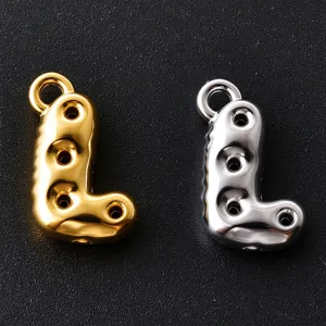 Close-up of gold and silver balloon-style letter L charms with ring loops and round holes